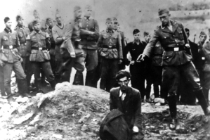 The Final Solution to the Jewish Question: An Einsatzgruppe D soldier about to shoot a Jew kneeling at a partially filled mass grave in Vinnitsa, Ukrainian SSR, Soviet Union, in 1942. The Einsatzgruppen were SS paramilitary task forces whose main purpose